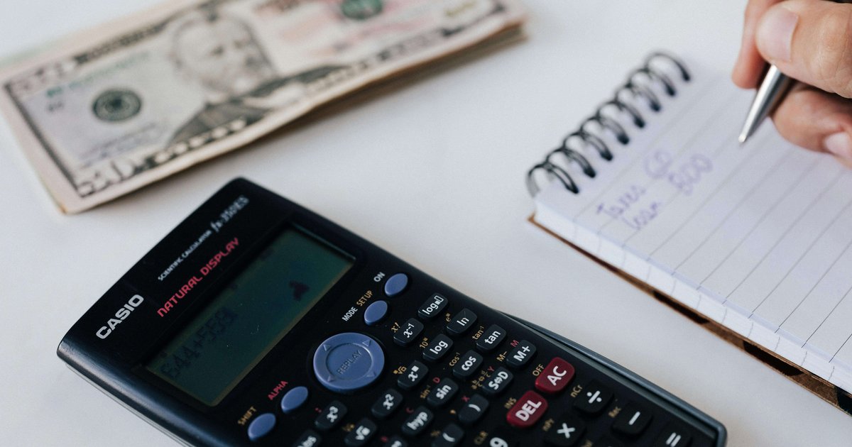 Calculator and budget notebook representing 50 30 20 budget rule South Africa